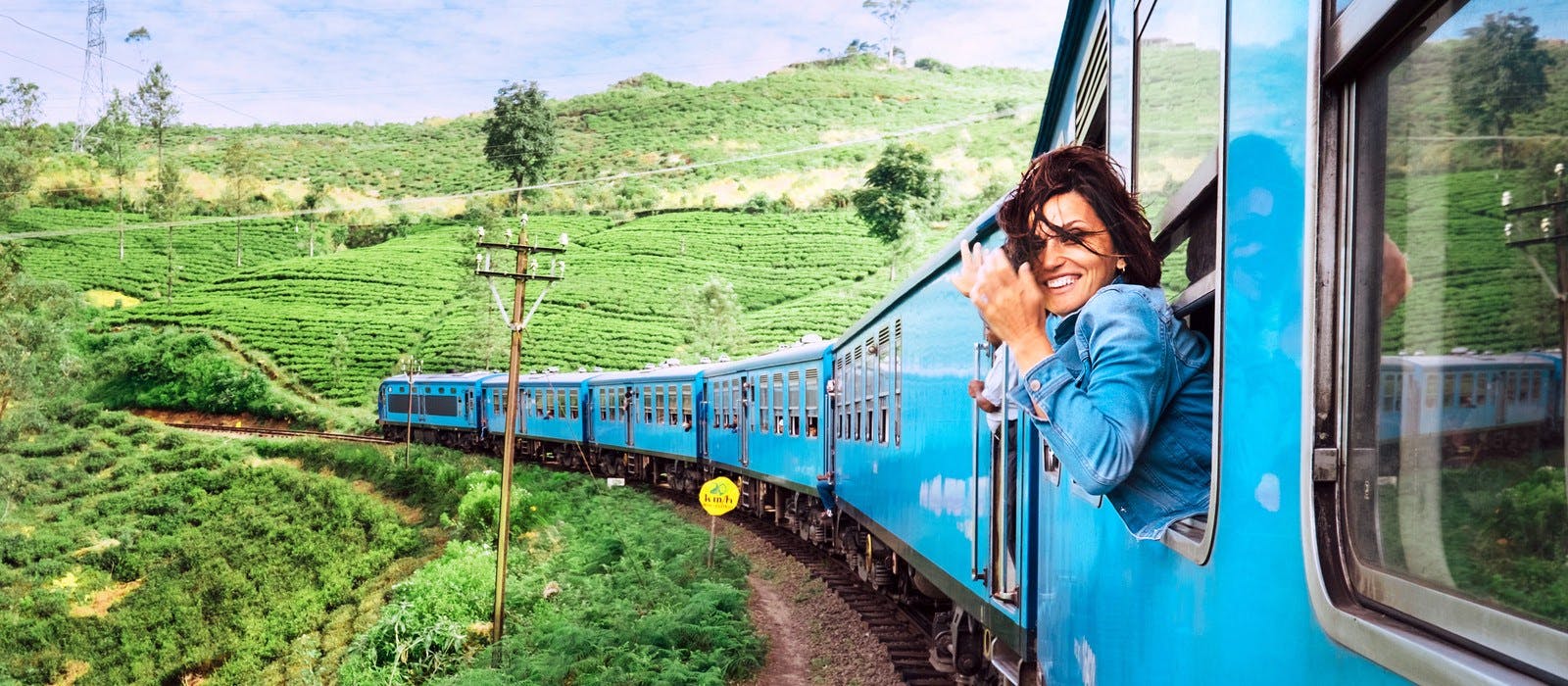 Backpacker reist duurzaam met de trein en geniet van het uitzicht terwijl ze uit het raam kijkt.