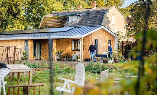 Gerben tuiniert met zijn schoonmoeder. Op de achtergrond zien we de kangoeroewoning en woning