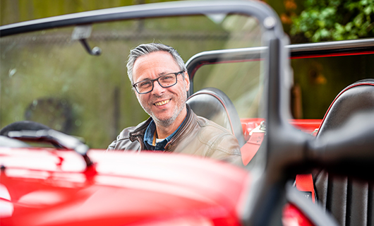 Martijn in zijn rode sportauto