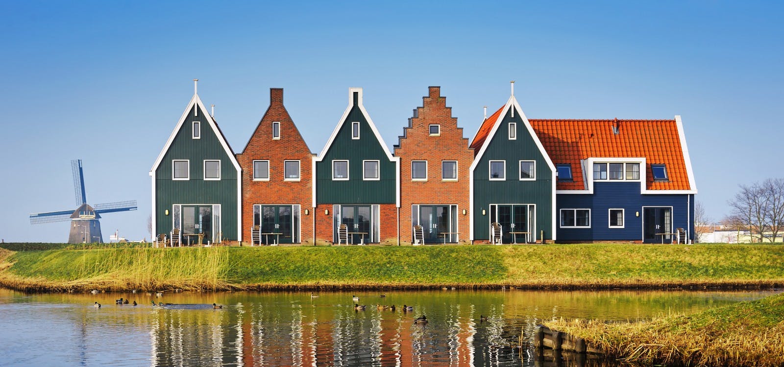 leuk gekleurde huisjes met een molen op de achtergrond